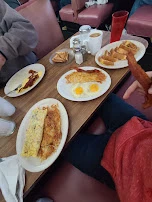 Omelet with Hasbrowns Eggs Bacon Hashbrowns and French Toast
